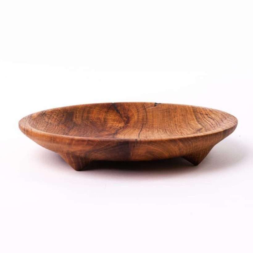 Drveni tanjir za posluženje napravljen iz celog komada drveta. Izradjen od hrasta, rustičan i sa nogicama. Slika sa strane. Pogodan za serviranje sočnije hrane.